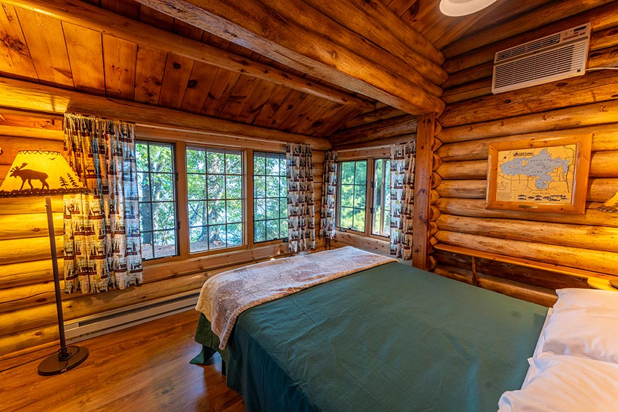 Cabin Interior with Queen bed and beautiful lake view at Cabin O' Pines Resort & Campground